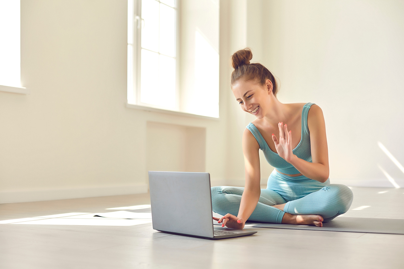 Girl Greeting Coach Online on Laptop Screen before Online Yoga Lesson